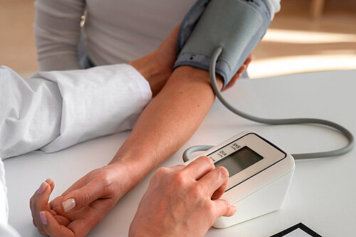 Doctor taking someones blood pressure